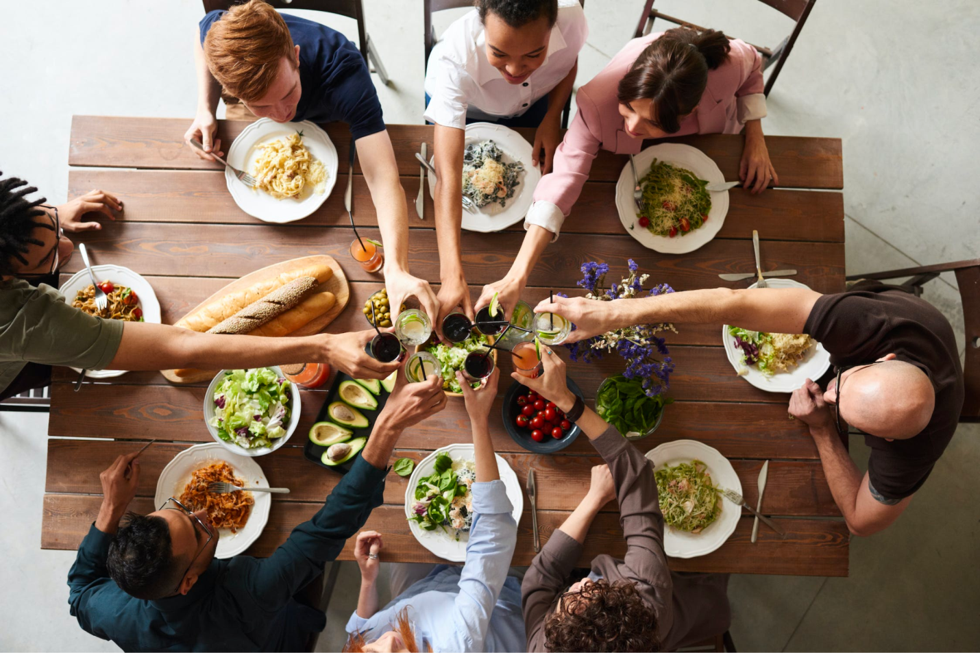 An overhead view of a table with dinner guests at a table.